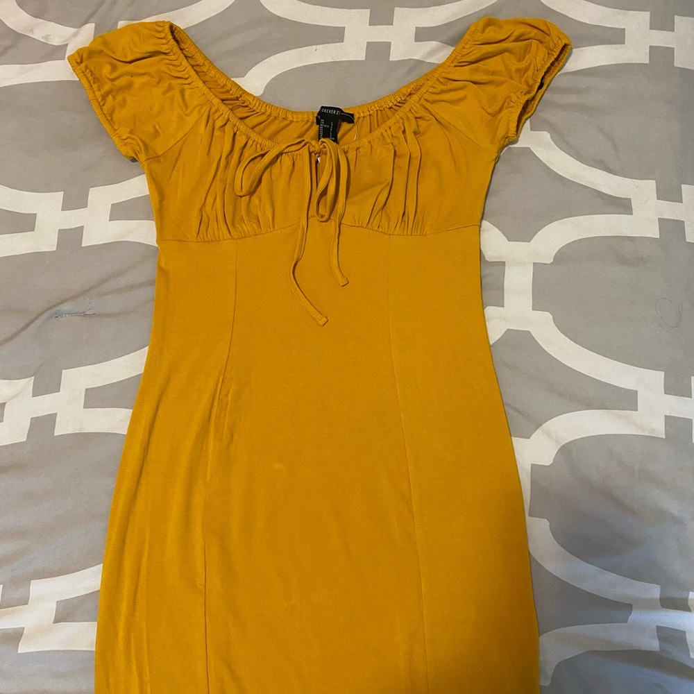 Off the shoulders Mustard color dress.